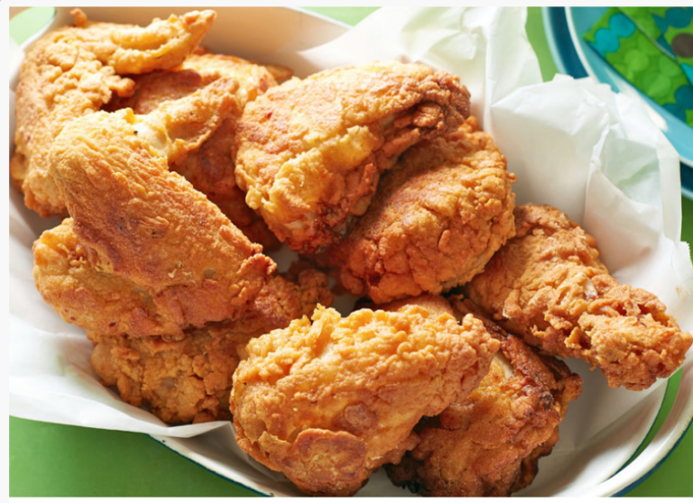 Basket of golden fried chicken pieces lined with paper